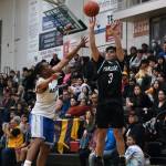 Yakutats Arthur Adams (3) shoots over Angoons JJ Jack Nixon during the Gold Medal tournament, Tuesday, March 21, at Juneau-Douglas High School: Yadaa.at Kalé. (Klas Stolpe / For the Juneau Empire)