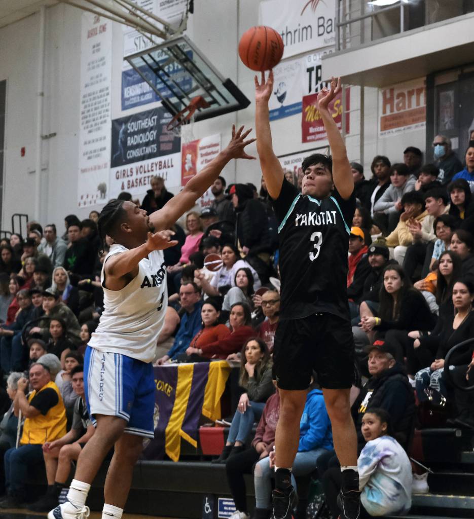 Yakutats Arthur Adams (3) shoots over Angoons JJ Jack Nixon during the Gold Medal tournament, Tuesday, March 21, at Juneau-Douglas High School: Yadaa.at Kalé. (Klas Stolpe / For the Juneau Empire)