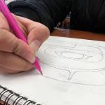 Makaley Johnson works on a formline drawing. (Courtesy Photo / David Sheakley-Early)