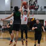 Kakes Shawn Merry (3) is defended by Haines Kirby Faverty (35) as Haines Kai Sato-Franks (1) and Dylan Swinton (32) look on during the Gold Medal tournament, Wednesday, March 22, at Juneau-Douglas High School: Yadaa.at Kalé. (Klas Stolpe/For the Juneau Empire)