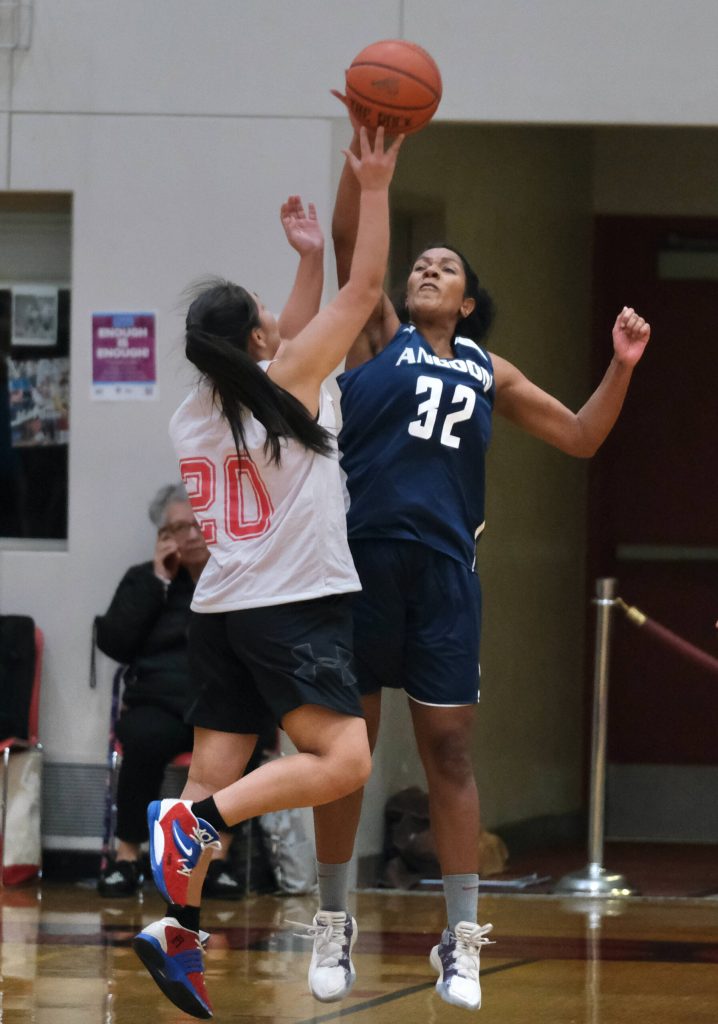 Angoons Tasha Heumann (32) blocks a shot by Kakes Alexis Copsey (20) during Thursday action at the Juneau Lions Club 74th Annual Gold Medal Basketball Tournament at Juneau-Douglas High School: Yadaa.at Kalé. (Klas Stolpe/For the Juneau Empire)