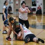 Kakes Monica Ashenfelter signals for a timeout as teammate Janessa Ashenfelter battles for a loose ball with Angoons Carmeleeda Estrada and Ladonna Byers during Thursday action at the Juneau Lions Club 74th Annual Gold Medal Basketball Tournament at Juneau-Douglas High School: Yadaa.at Kalé. (Klas Stolpe/For the Juneau Empire)