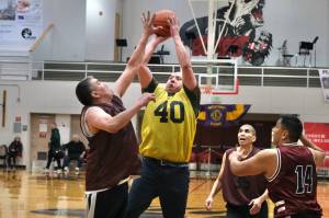 Hoonahs Albert Hinchman defends as hot by Sitkas Patrick Miller (40) as Hoonahs Andy Gray, Louie White Jr. and Joe Coronell look on during Thursday action at the Juneau Lions Club 74th Gold Medal Basketball Tournament at Juneau-Douglas High School: Yadaa.at Kalé. (Klas Stolpe/For the Juneau Empire)