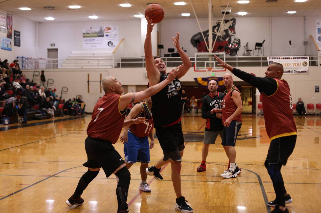 Klukwans Russ Stevens (23) drives to the hoop early in a Masters Bracket game against Juneau. (Ben Hohenstatt / Juneau Empire)