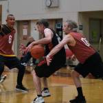 Juneaus Doug Drazkowski (05) strips the ball from behind Klukwans Dave Buss (22) as Juneaus James Mercer (6) keeps Klukwans Russ Stevens out of the play during Thursday night action in the Juneau Lions Club 74th Annual Gold Medal Basketball Tournament at the Juneau-Douglas High School: Yadaa.at Kalé gymnasium. (Klas Stolpe/For the Juneau Empire)