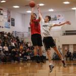 Hydaburgs Darren Edenshaw shoots from deep while Juneaus Kaleb Tompkins attempts to disrupt the shot. Edenshaw finished with a game-high 24 points, but Juneau left with an 86-70 victory and a B Bracket championship game berth. (Ben Hohenstatt / Juneau Empire)