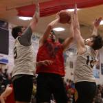 Hydaburgs Darren Edenshaw shoots while sandwiched by Juneaus Stewart Conn (9) and Matt Seymour (10). He led his team with 24 points. (Ben Hohenstatt / Juneau Empire)