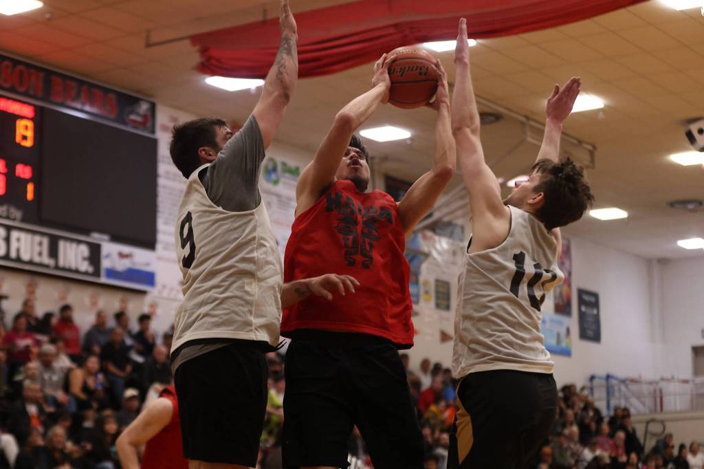 Hydaburgs Darren Edenshaw shoots while sandwiched by Juneaus Stewart Conn (9) and Matt Seymour (10). He led his team with 24 points. (Ben Hohenstatt / Juneau Empire)