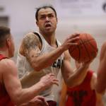 Juneaus Terrence Wheat drives to the hoop late in a Juneau B Bracket win against Hydaburg. The Thursday night win punched Juneaus ticket to the B Bracket championship game on Saturday. (Ben Hohenstatt / Juneau Empire)