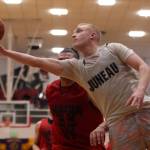Juneaus Chase Saviers extends for a scoop shot late in a Juneau win against Hydaburg. Saviers finished the Thursday night B Bracket game with 16 points. (Ben Hohenstatt / Juneau Empire)