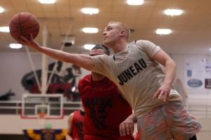 Juneaus Chase Saviers extends for a scoop shot late in a Juneau win against Hydaburg. Saviers finished the Thursday night B Bracket game with 16 points. (Ben Hohenstatt / Juneau Empire)