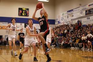 JDHS senior Orion Dybdahl begins ascending for a dunk with Kayhis Jared Rhoads (15) and Marcus Stockhausen (34) in pursuit. Orion was named Player of the Game and led his team in scoring on Friday against Colony High School in this years state competition in Anchorage. (Ben Hohenstatt / Juneau Empire File)