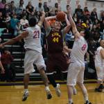 Klukwans Andrew Friske (44) shoots under pressure from Hoonahs Lucas Johnson (21) and Donald Dybdahl (8) during Saturdays C Bracket elimination Gold Medal Basketball game at Juneau-Douglas High School: Yadaa.at Kalé. (Klas Stolpe/For the Juneau Empire)