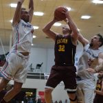 Hoonahs DJ Lindstrom (4) and Braxton Booze (23) defend Klukwans Brian Friske (32) during Saturdays C Bracket elimination game. (Klas Stolpe/For the Juneau Empire)