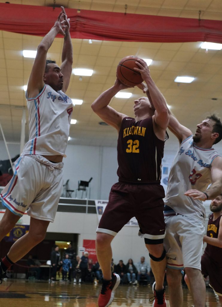 Hoonahs DJ Lindstrom (4) and Braxton Booze (23) defend Klukwans Brian Friske (32) during Saturdays C Bracket elimination game. (Klas Stolpe/For the Juneau Empire)