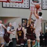 Hoonah's Anthony Lindoff (0) scores over Klukwan's Kent Larson (9) during Saturday's C Bracket elimination game. (Klas Stolpe/For the Juneau Empire)