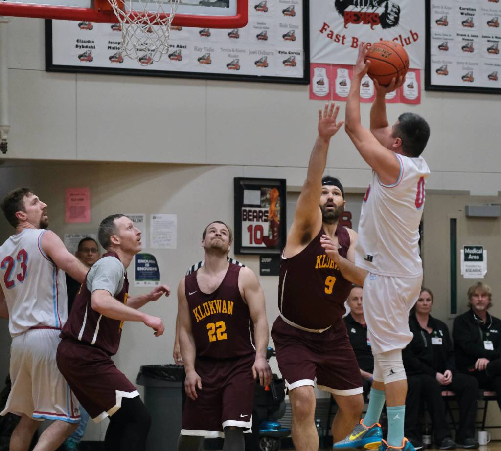 Hoonah's Anthony Lindoff (0) scores over Klukwan's Kent Larson (9) during Saturday's C Bracket elimination game. (Klas Stolpe/For the Juneau Empire)