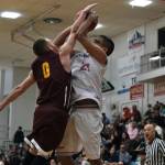 Klukwans Daniel Stickler (0) defends a shot by Hoonahs Lucas Johnson (21) during Fridays C Bracket elimination game. Klukwan won 78-65 and will play Juneau Filcom in Saturdays championship. (Klas Stolpe/For the Juneau Empire)