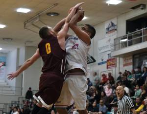 Klukwans Daniel Stickler (0) defends a shot by Hoonahs Lucas Johnson (21) during Fridays C Bracket elimination game. Klukwan won 78-65 and will play Juneau Filcom in Saturdays championship. (Klas Stolpe/For the Juneau Empire)