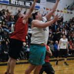 Angoons Kendrick Payton scores as Hydaburgs George Peratrovich defends during Saturdays B Bracket double-overtime elimination game. (Klas Stolpe/For the Juneau Empire)