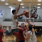 Angoons Kendrick Payton scores as Hydaburgs George Peratrovich defends during Saturdays B Bracket double-overtime elimination game. (Klas Stolpe/For the Juneau Empire)