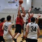 Hydaburgs George Peratrovich tips in teammate Vinnie Edenshaws missed free throw with 0.3 seconds remaining in overtime, forching a second overtime in a win over Angoon during Friday nights elimination game at the Gold Medal Tournament in Juneau. (Klas Stolpe/For the Juneau Empire)
