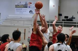 Hydaburgs George Peratrovich tips in teammate Vinnie Edenshaws missed free throw with 0.3 seconds remaining in overtime, forching a second overtime in a win over Angoon during Friday nights elimination game at the Gold Medal Tournament in Juneau. (Klas Stolpe/For the Juneau Empire)