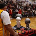 Juneau Lions Club President Edward Hotch wheels out awards following Juneaus B Bracket victory in the Juneau Lions Club 74th Gold Medal Basketball Tournament. At halftime, Hotch received an award of his own when Sen. Jesse Kiehl presented Edward and Janice Hotch with a legislative citation recognizing the Hotches longtime work in making Gold Medal a possibility. Kiehl said theres not much universally agreed upon in the Capitol, but the goodness of the return of Gold Medal is an exception. (Ben Hohenstatt / Juneau Empire)