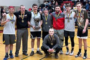 Juneaus Gold Medal Basketball Tournament B Bracket team poses for a group photo after winning the B bracket championship game in this years Gold Medal Basketball Tournament Saturday night at JDHS. (Jonson Kuhn / Juneau Empire)