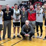 Juneaus Gold Medal Basketball Tournament B Bracket team poses for a group photo after winning the B bracket championship game in this years Gold Medal Basketball Tournament Saturday night at JDHS. (Jonson Kuhn / Juneau Empire)