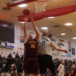 Filcoms Ray Zimmer (0) blocks a shot from Klukwans Jess McGraw in the first half of the Juneau Lions Club 74th Gold Medal Basketball Tournament C Bracket Championship Game Saturday in Juneau-Douglas High School: Yadaa.at Kalés gymnasium. (Ben Hohenstatt / Juneau Empire)