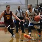 Filcoms Larry Cooper (10) gets past Klukwans Bryan Combs (22) during the C Bracket Championship at the Gold Medal Basketball Tournament, Saturday, March 25, at Juneau-Douglas High School: Yadaa.at Kalé. (Klas Stolpe/For the Juneau Empire)