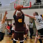 Klukwans Stuart Dewitt (40) shoots under pressure from Filcoms Ray Zimmer (0) and Alex Heumann (24) during the C Bracket Championship at the Gold Medal Basketball Tournament, Saturday, March 25, at Juneau-Douglas High School: Yadaa.at Kalé. (Klas Stolpe/For the Juneau Empire)