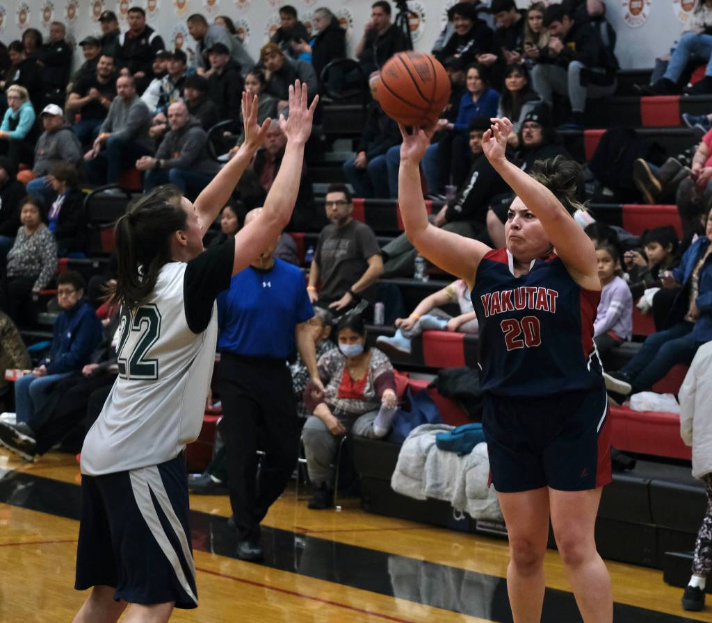 Yakutats Rose Fraker (20) shoots over POWs Nani Weimer (22) during the Gold Medal Basketball Tournament, Saturday, March 25, at Juneau-Douglas High School: Yadaa.at Kalé. (Klas Stolpe/For the Juneau Empire)