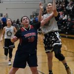 Pows Cassie Williams is fouled by Yakutats Nadine Fraker (10) in the Womens Championship game of the Gold Medal Basketball Tournament, Saturday, March 25, at Juneau-Douglas High School: Yadaa.at Kalé. (Klas Stolpe/For the Juneau Empire)