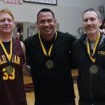 Jesse McGraw, Matt Carle and Andrew Friske pose for a photo after their induction into the Gold Medal Hall of Fame, Friday, March 24, during the Juneau Lions Club 74th Annual Gold Medal Basketball Tournament at the Juneau-Douglas High School: Yadaa.at Kalé gymnasium. (Klas Stolpe/For the Juneau Empire)