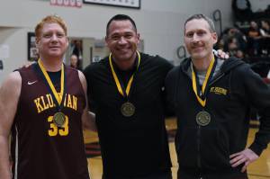 Jesse McGraw, Matt Carle and Andrew Friske pose for a photo after their induction into the Gold Medal Hall of Fame, Friday, March 24, during the Juneau Lions Club 74th Annual Gold Medal Basketball Tournament at the Juneau-Douglas High School: Yadaa.at Kalé gymnasium. (Klas Stolpe/For the Juneau Empire)
