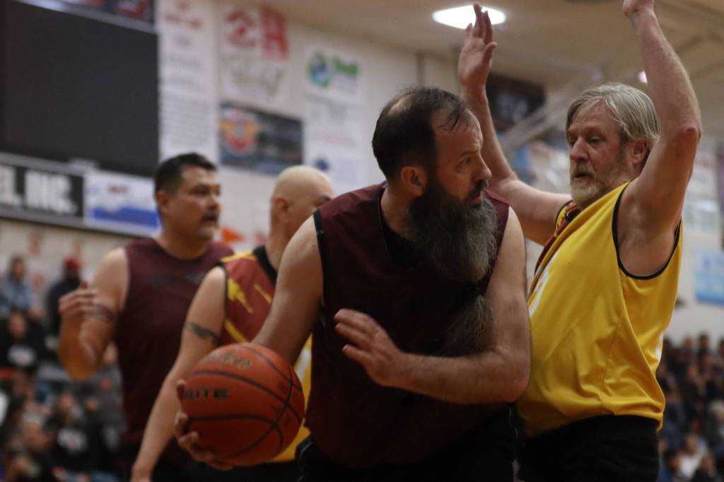Hoonahs Mark Prpich (22) drives the lane against Juneaus Doug Draowski (5) on Saturday during the Gold Medal championship game for M bracket at JDHS. Prpich finished the game with 10 points. (Ben Hohenstatt / Juneau Empire)
