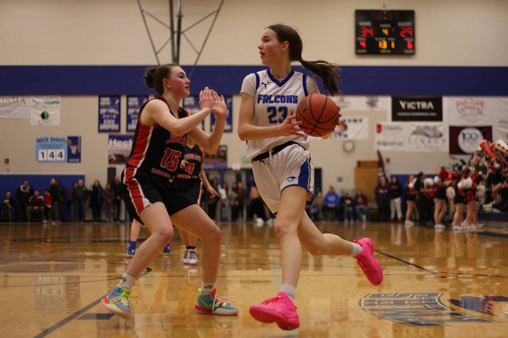 TMHS Cailynn Baxter (23) drives while guarded by JDHS Gwen Nizich (15) during a Region V Tournament game at TMHS. Baxter earned second team all-state honors for her play this season.