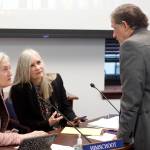 Mark Sabbatini / Juneau Empire 
State representatives Rebecca Himschoot, I-Sitka, left, and Andi Story, D-Juneau, discuss a proposal requiring school districts to maintain a public online checkbook with Rep. George Rauscher, R-Sutton, the bills sponsor, during a break in a House Education Committee meeting Wednesday. The two Southeast Alaska representatives expressed concerns about cyber security and small remote districts that do not have official websites.