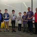 (Left to right): Britt Smith, President of the National Engineering Society, Floyd Dryden Middle School team members: Tyler Oudekerk, Caden Morris, Dan Degener, FDMS Coach Alan Degener and State Mathcounts Coordinator Clark Milne. FDMS team receiving their second place trophies at the state Mathcounts tournament in Fairbanks on March 25.
