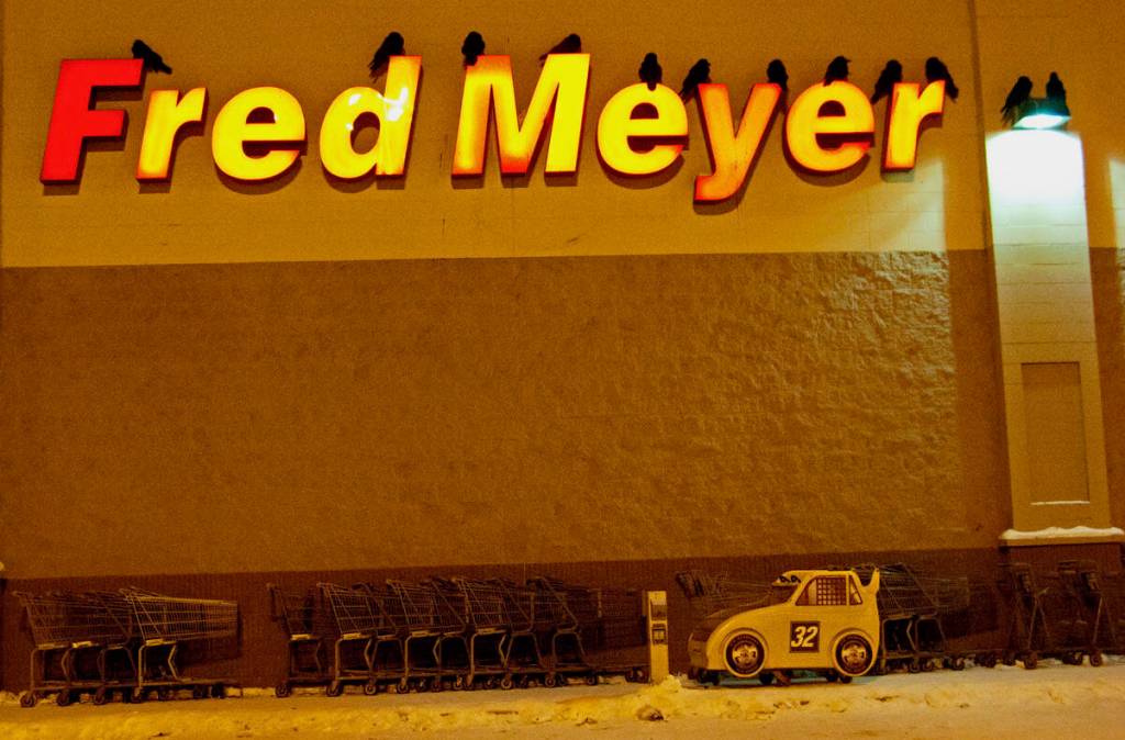 Ravens roost for the night on the letters of a grocery store in Fairbanks. (Courtesy Photo / Douglas Yates)
