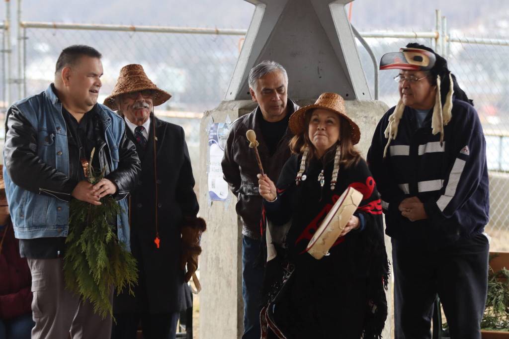 Nancy Barnes leads Tinglit, Haida and Tsimshian peoples in song and dance on Friday at Marine Park at the site where the Kootéeyaa Deiyí (Totem Pole Trail) along the downtown Juneau waterfront will be installed by April 22. (Jonson Kuhn / Juneau Empire)