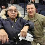 This March 28, 2023, photo shows Bruce Boolowon, left, posing with Maj. Gen. Torrence Saxe, the adjutant general of the Alaska National Guard, during a ceremony in Gambell, Alaska. Saxe presented Alaska Heroism Medals to Boolowon, the last surviving guardsman who helped rescue 11 Navy crewmen after they crash landed on St. Lawrence Island on June 22, 1955, and to the family members of 15 other guardsman who are now deceased. (AP Photo/Mark Thiessen)