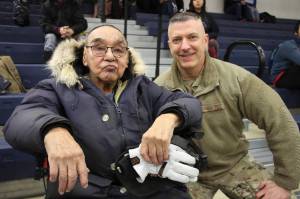 This March 28, 2023, photo shows Bruce Boolowon, left, posing with Maj. Gen. Torrence Saxe, the adjutant general of the Alaska National Guard, during a ceremony in Gambell, Alaska. Saxe presented Alaska Heroism Medals to Boolowon, the last surviving guardsman who helped rescue 11 Navy crewmen after they crash landed on St. Lawrence Island on June 22, 1955, and to the family members of 15 other guardsman who are now deceased. (AP Photo / Mark Thiessen)