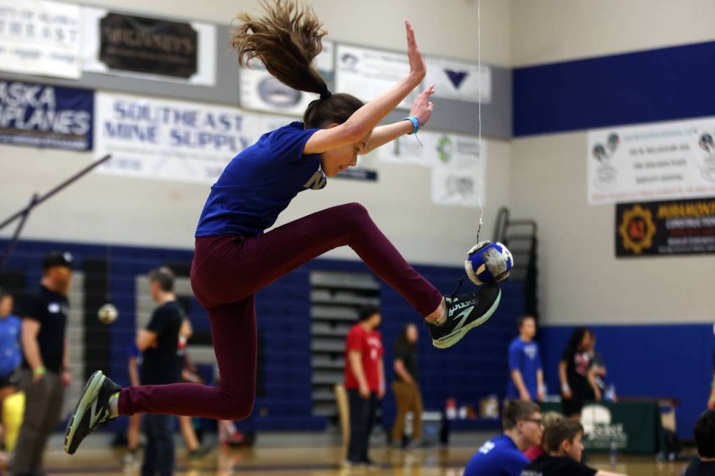 Madelyn Dreischbach, 13, jumps up to connect with the ball during the one-foot high kick event at this years Traditional Games. (Ben Hohenstatt / Juneau Empire)