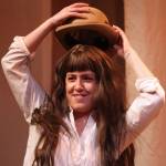 Jo March (Ema Zivkovic) places a recently swiped hat upon their head during rehearsal for Little Women, which opens Friday. (Ben Hohenstatt / Juneau Empire)