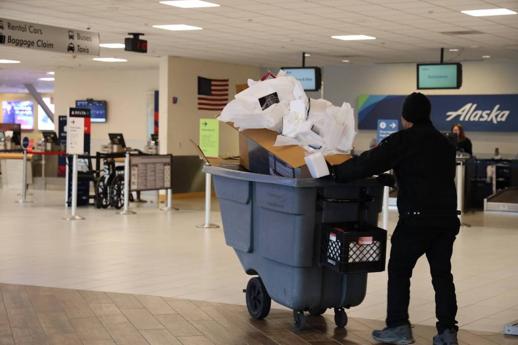 A custodial official wheels trash past the Alaska Airlines counter at Juneau International Airport at midday Wednesday. Leaders with the state House majority discussed having Alaska State Troopers search the airport after members of the minority caucus fled the Alaska State Capitol during the morning over a fight about education funding, in an attempt to prevent further action on the matter. Airport officials said they were not aware of lawmakers attempting to catch flights during the standoff. (Clarise Larson/ Juneau Empire)