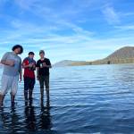 From left to right, Trevor Fredrickson, Sam Fredrickson and Beebuks Kookesh celebrate their arrival in Mole Harbor, on the east side of Admiralty Island and the end of the cross-Admiralty canoe route. (Courtesy Photo / Mary Catharine Martin)
