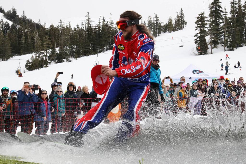 A snowboarder glides over the skim pond at Eaglecrest Ski Area as they partake in the return of the Slush Cup Saturday afternoon. (Clarise Larson / Juneau Empire)